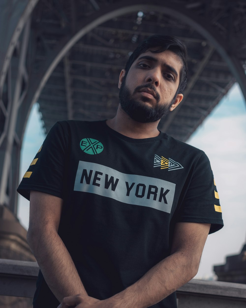 standing man wearing black t-shirt