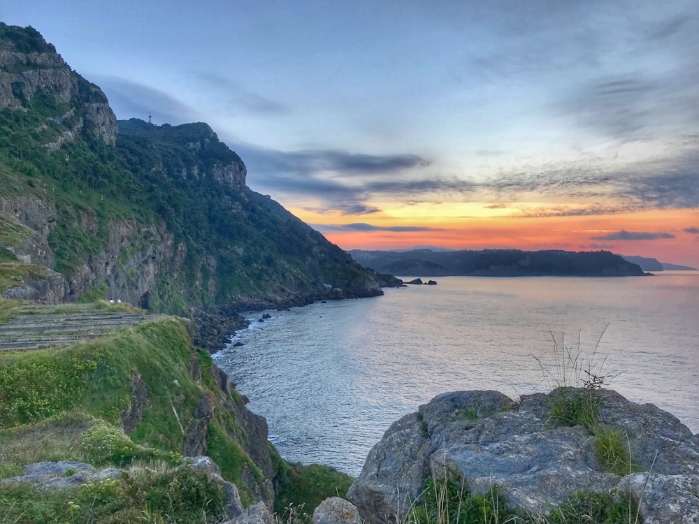 calm body of water during sunset