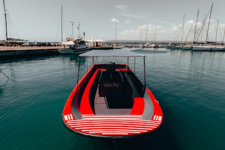 red boat on body of water