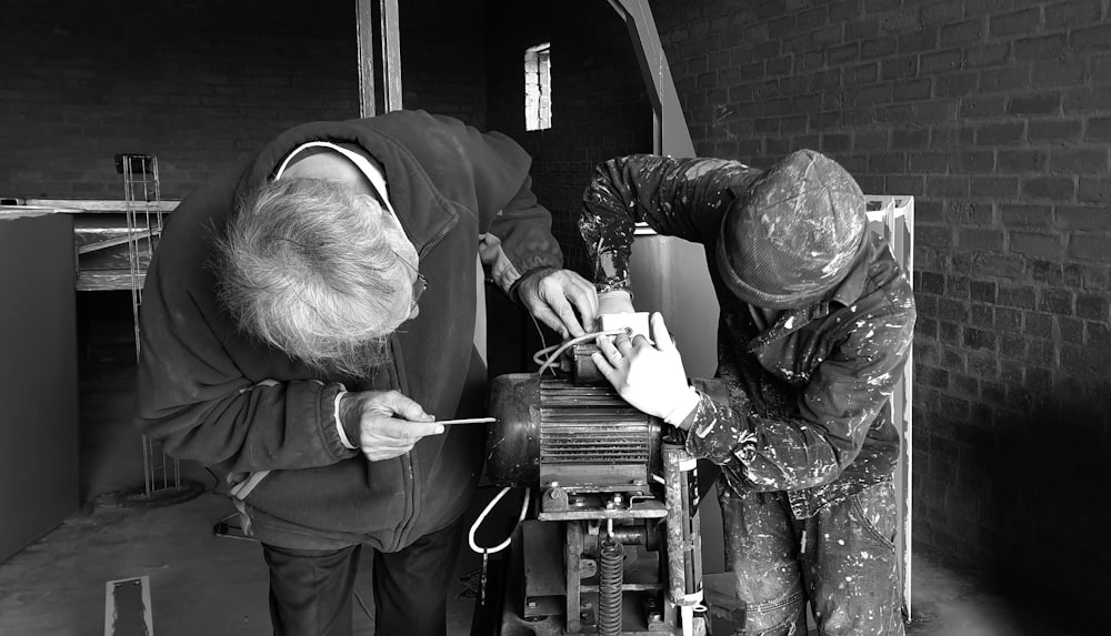 two person fixing AC motor