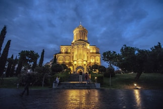 A serene church entrance at dusk with soft glowing lights.
