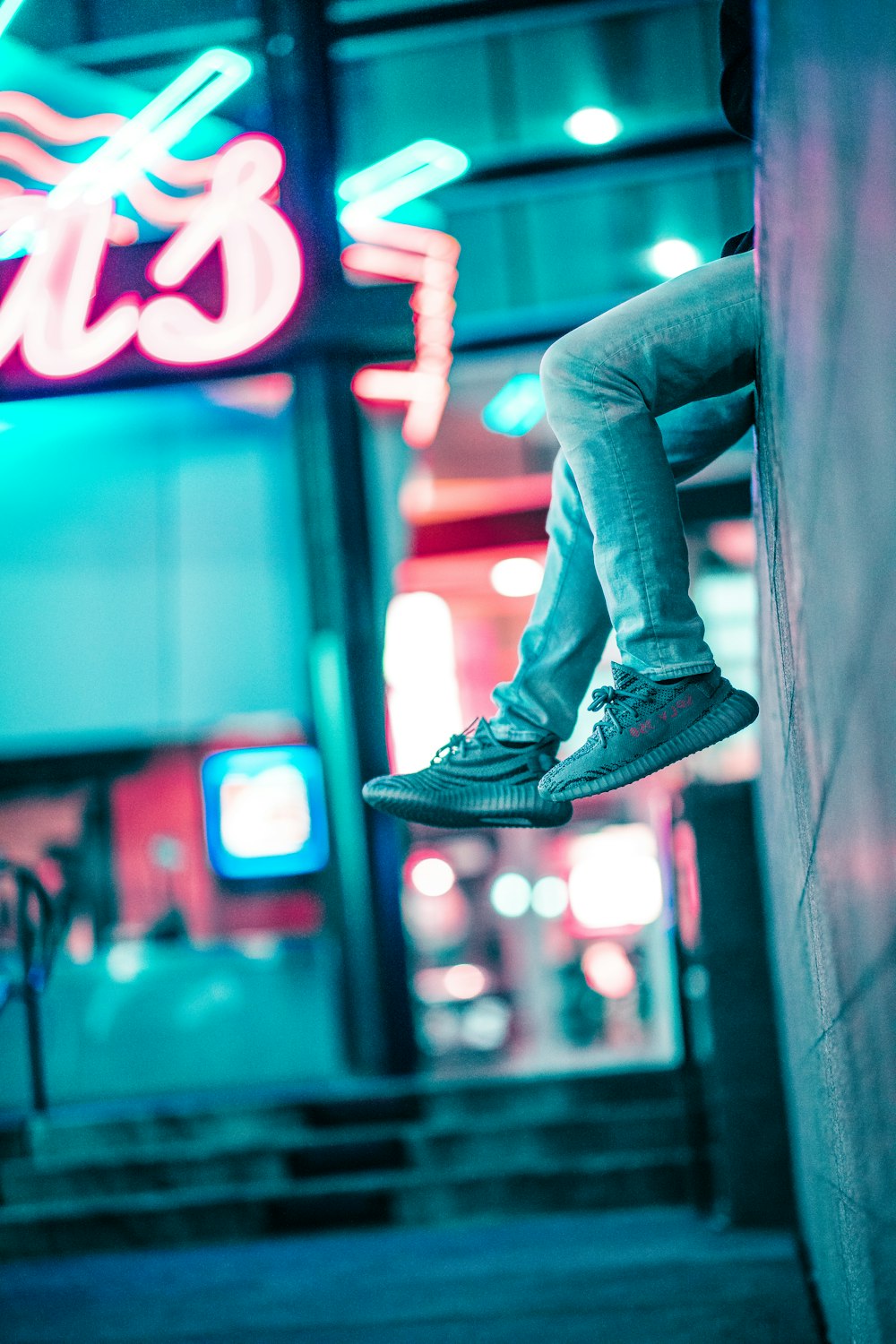 person sitting on brick wall