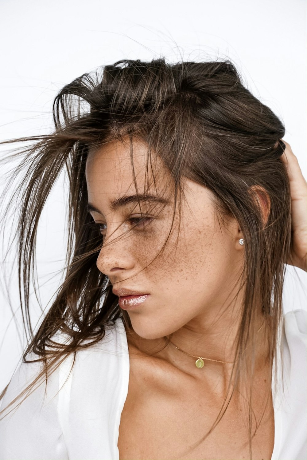 woman holding her hair looking to her right side