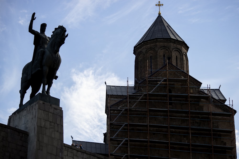 gray statue near building