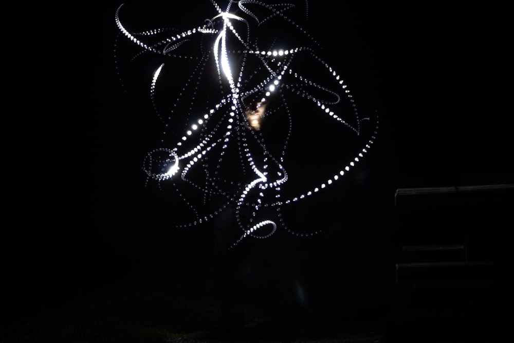 a black and white photo of some lights in the dark