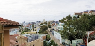 A hillside lot with a panoramic view of the city and mountains in the distance.