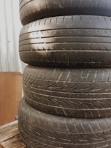 Stack of tires and alloy wheels ready for installation.