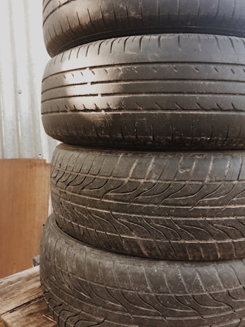 Pallets loaded with tires being prepared for shipment inside a busy logistics center.