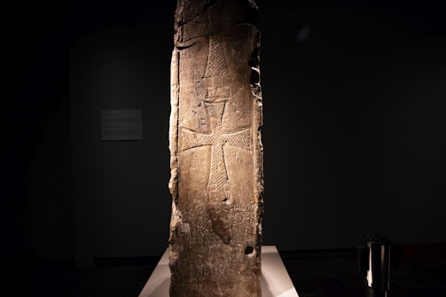 An ancient Masonic symbol carved in stone, illuminated by soft light.