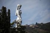 statue of woman in dress during daytime
