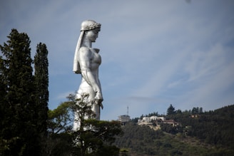 statue of woman in dress during daytime