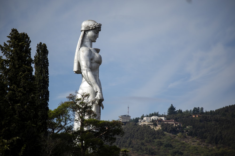 statue of woman in dress during daytime