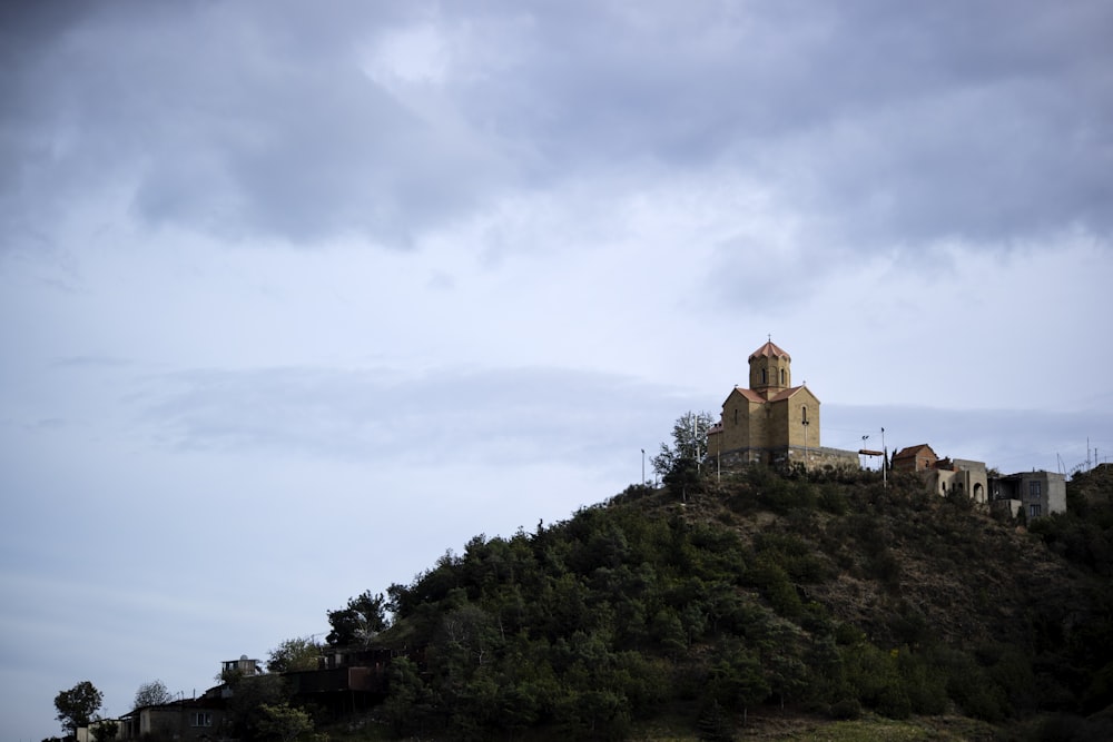 brown building on top of mountain