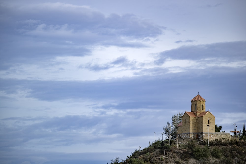 beige cathedral on cliff during daytime