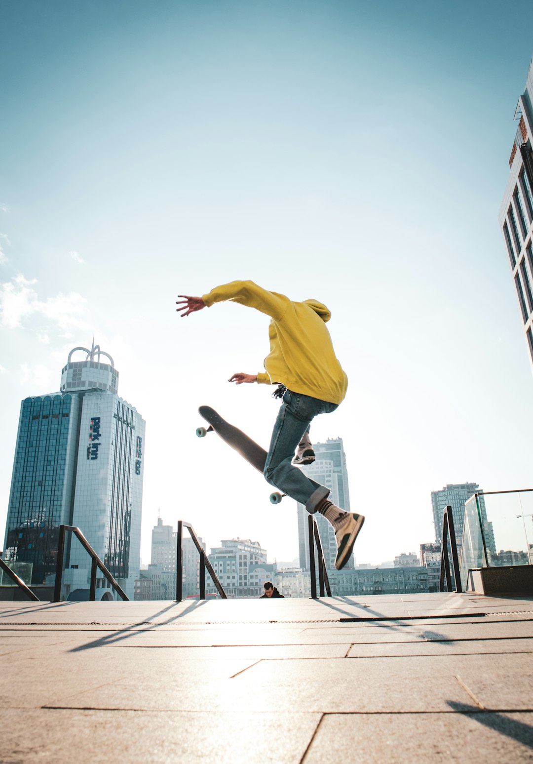 man doing tricks on skateboard during daytime