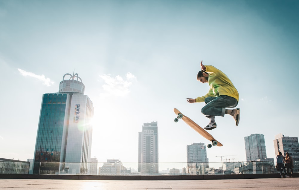 man wearing yellow jacket doing ollie