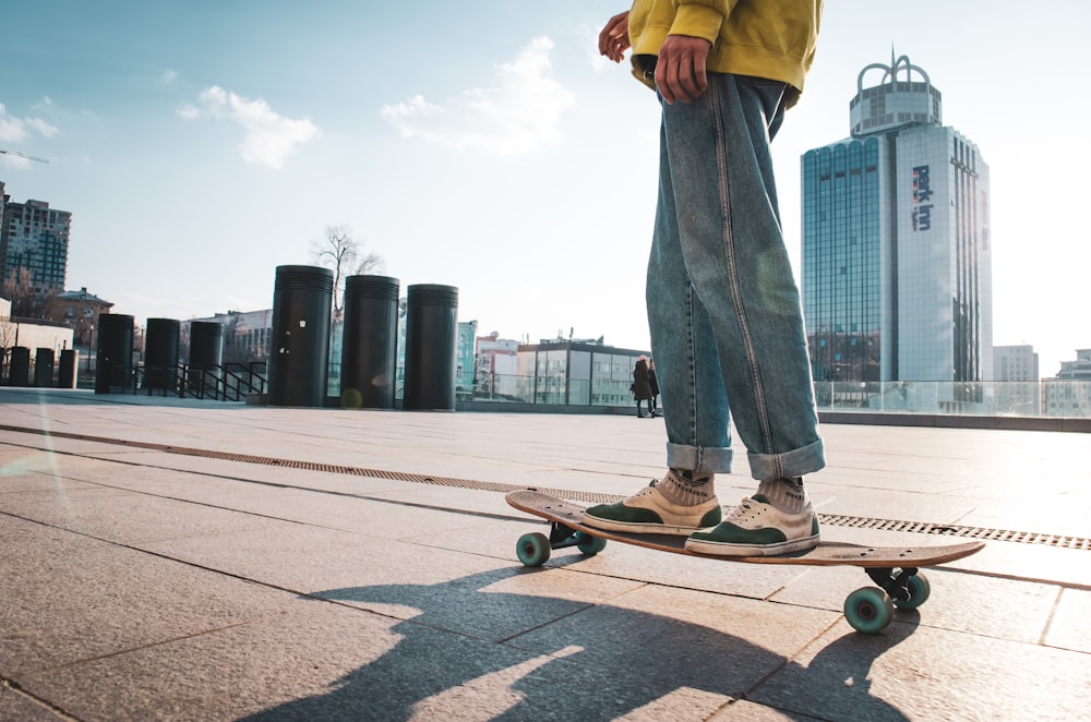 man riding skateboard near buildings during day