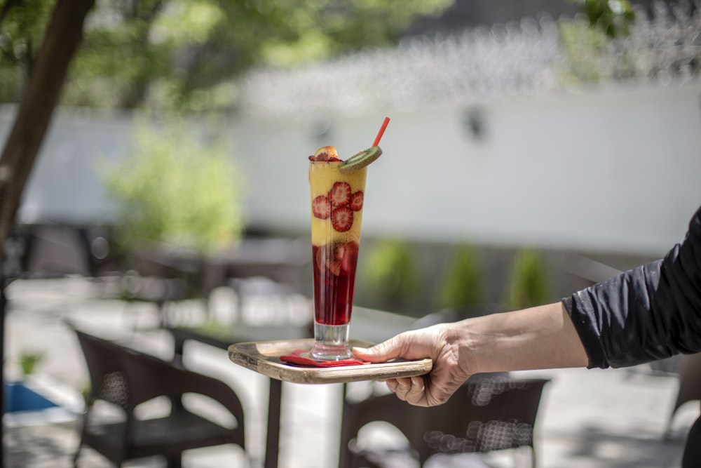 yellow and red drink in clear highball glass