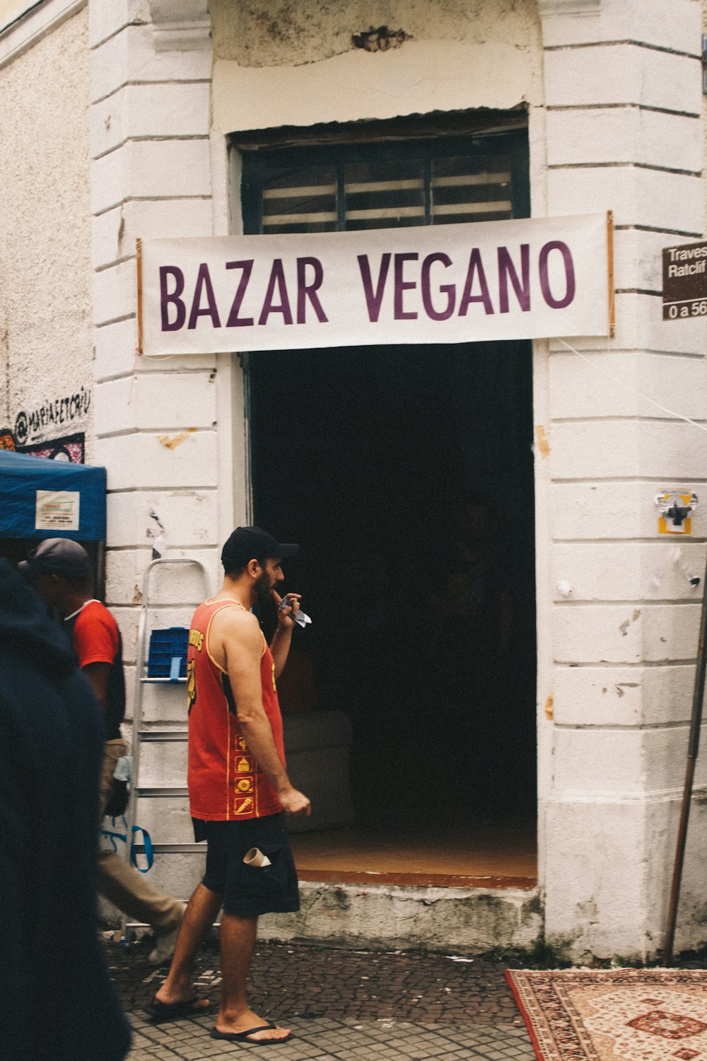 man standing in front of Bazar Vegano entrance