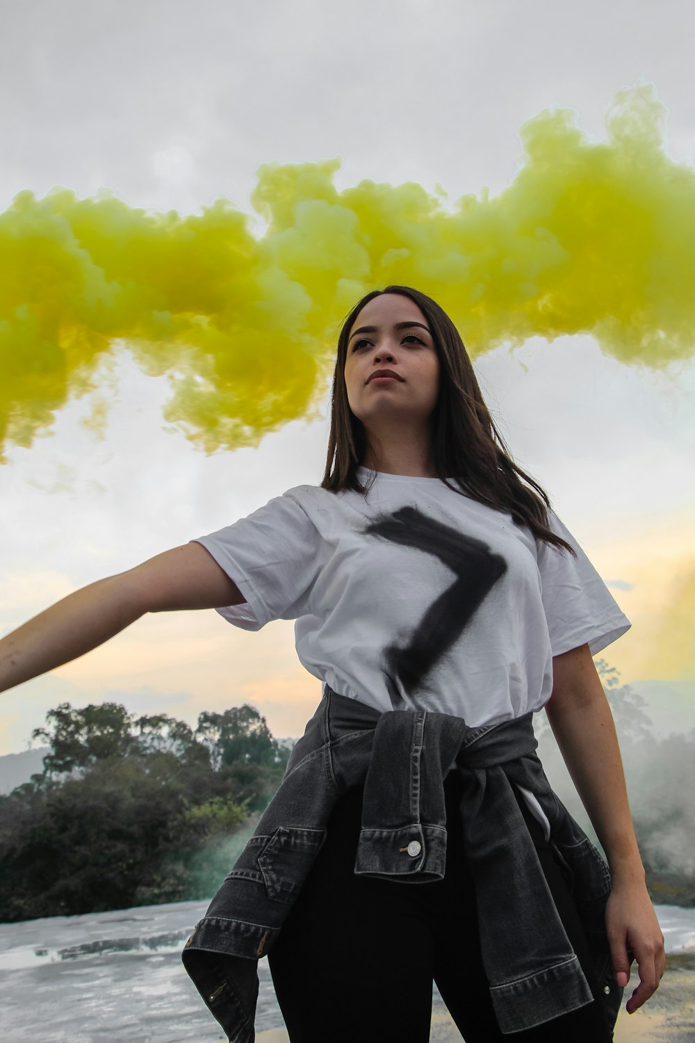 woman holding yellow smoke bomb