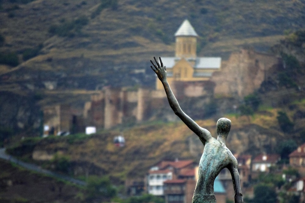 waving statue during daytime