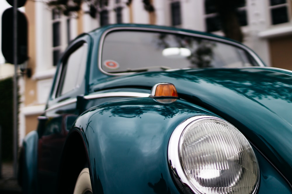 selective focus photography of green Volkswagen Beetle