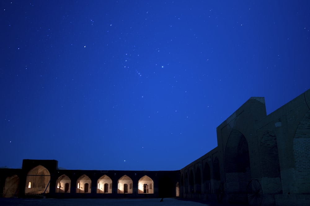 a building with a lot of windows and a sky full of stars