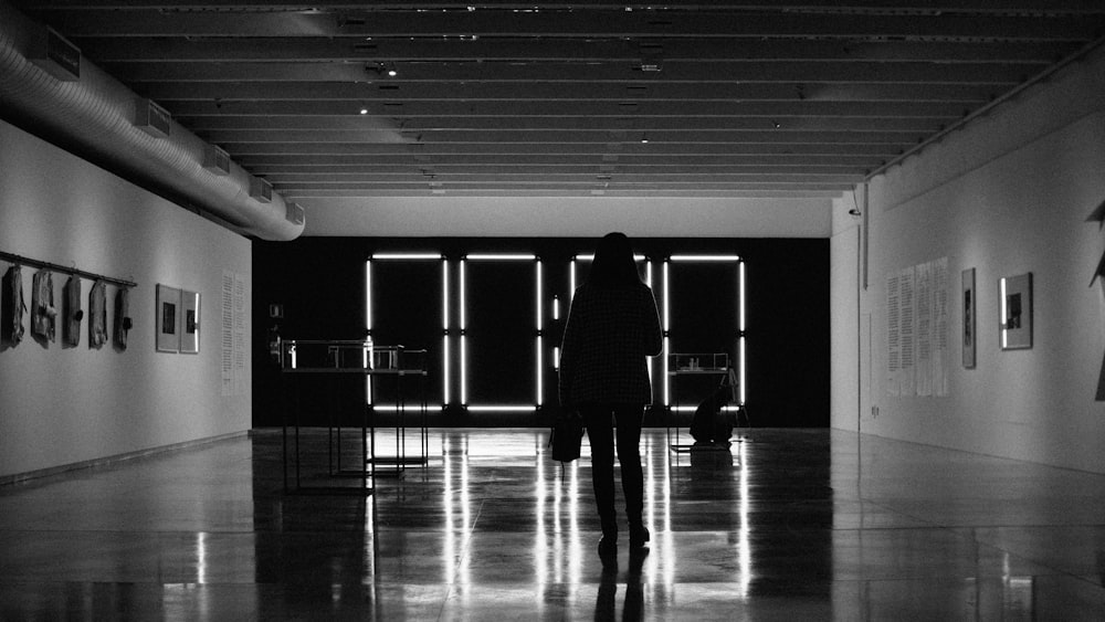 silhouette of woman standing in dark room