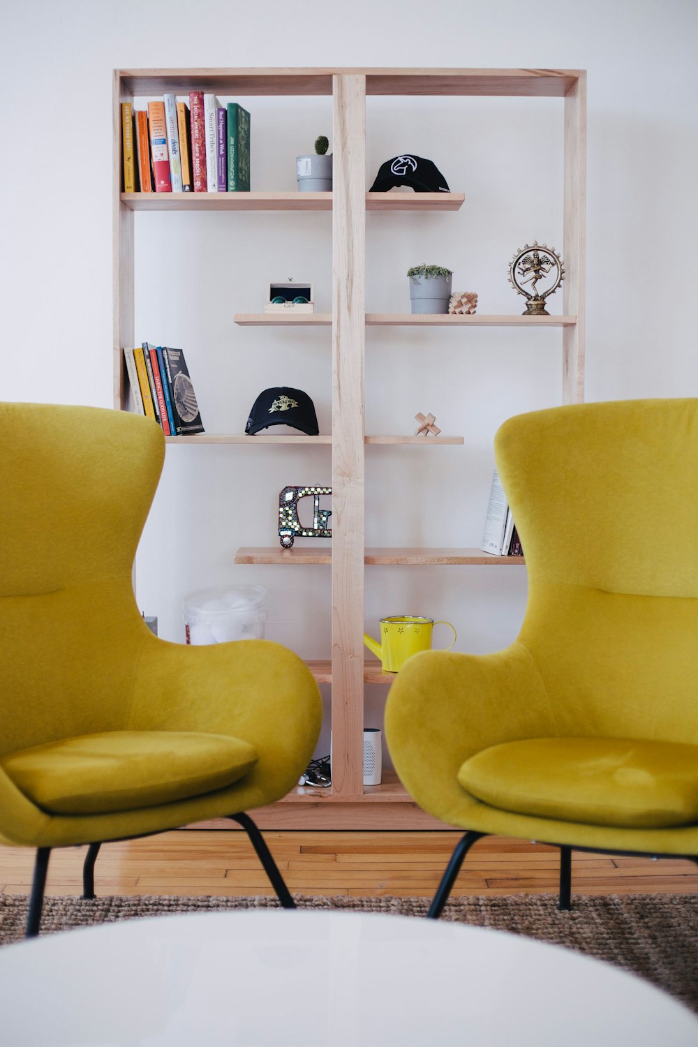 Duas cadeiras amarelas perto da prateleira marrom