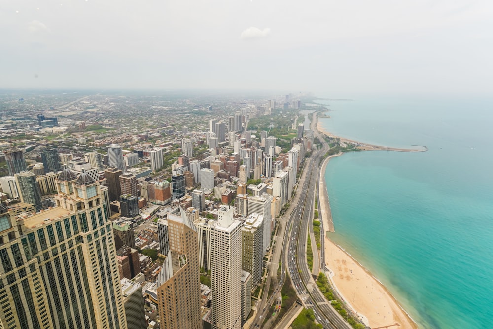 aerial photography of white sand beach and cityscape during daytime