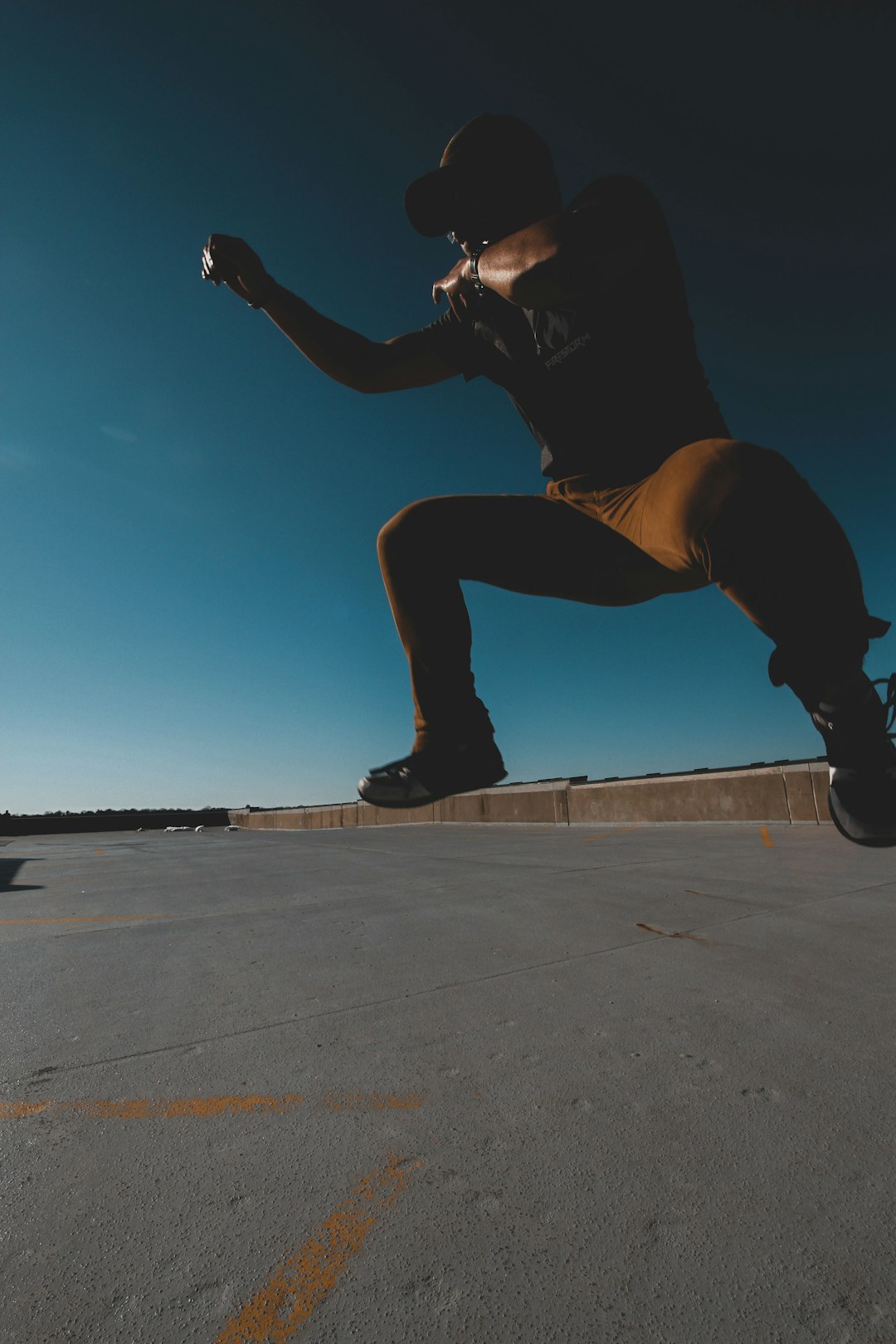 man jumping on concrete road