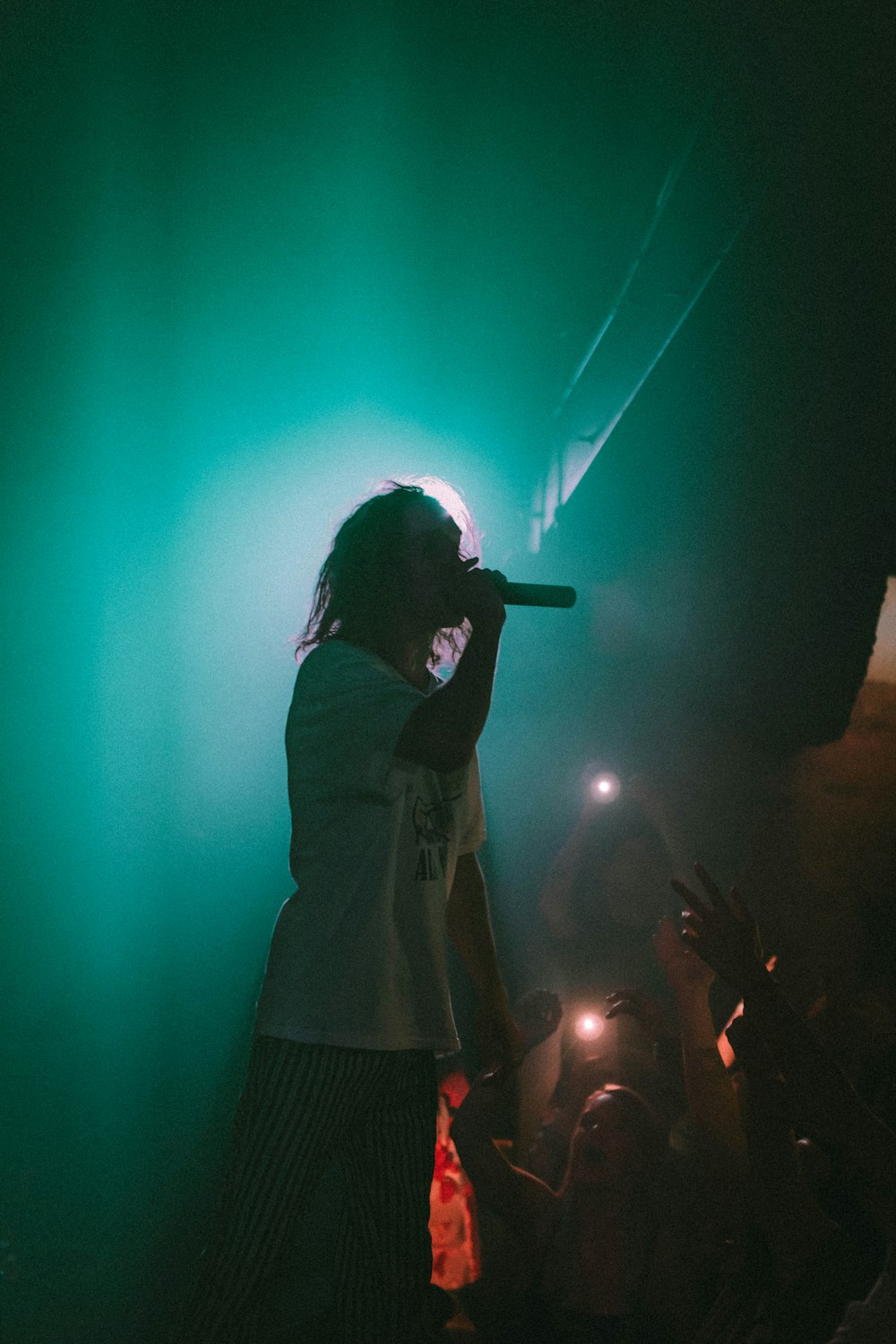 man singing on stage