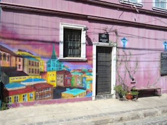 Colorful murals painted by azm volunteers brightening a neighborhood wall.