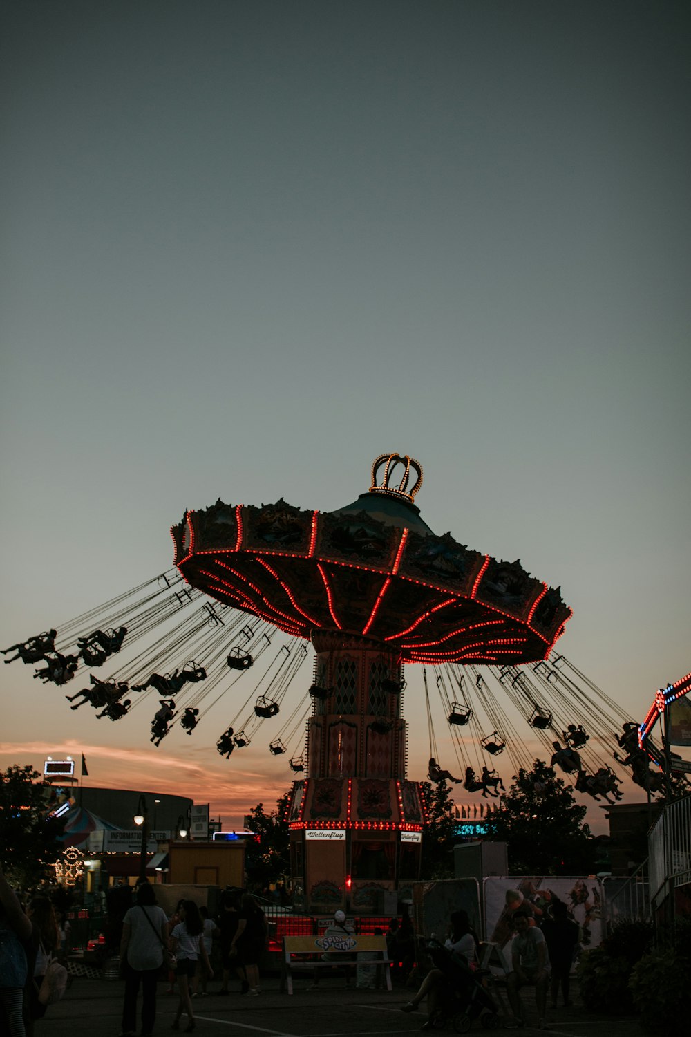 people riding swing ride during night