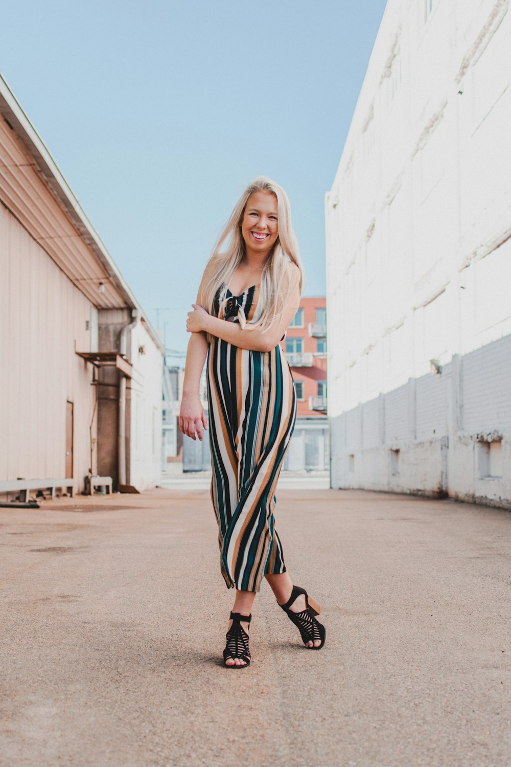 woman wearing black and brown striped sleeveless rompers