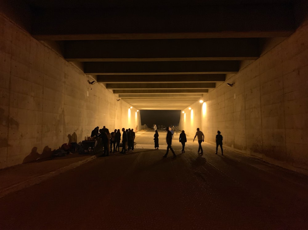 people standing in underground road