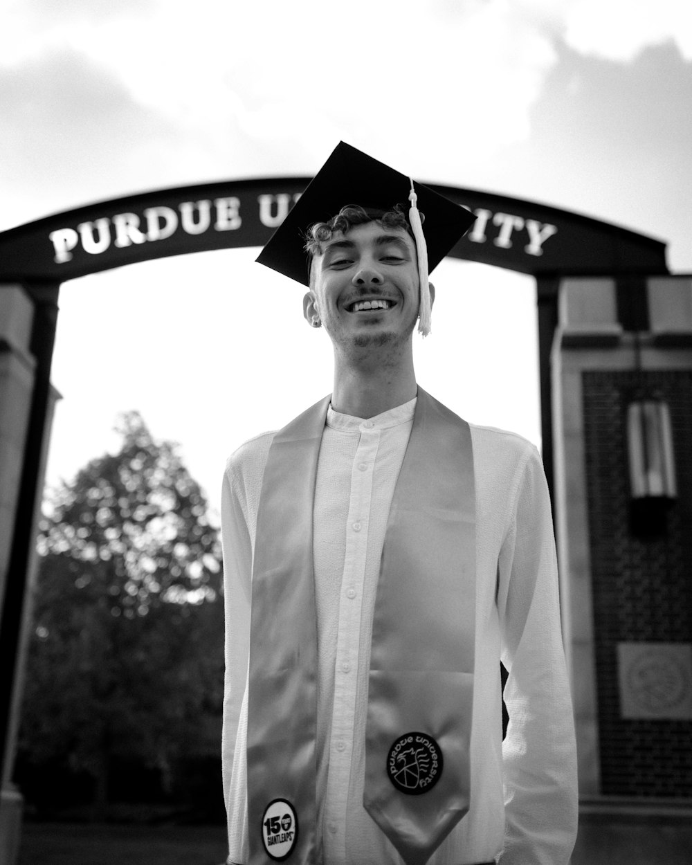 man in thawb with mortar board smiling