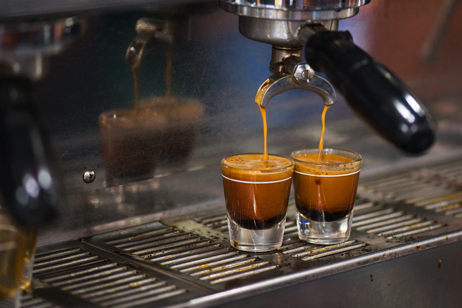 Double espresso pouring from a commercial machine
