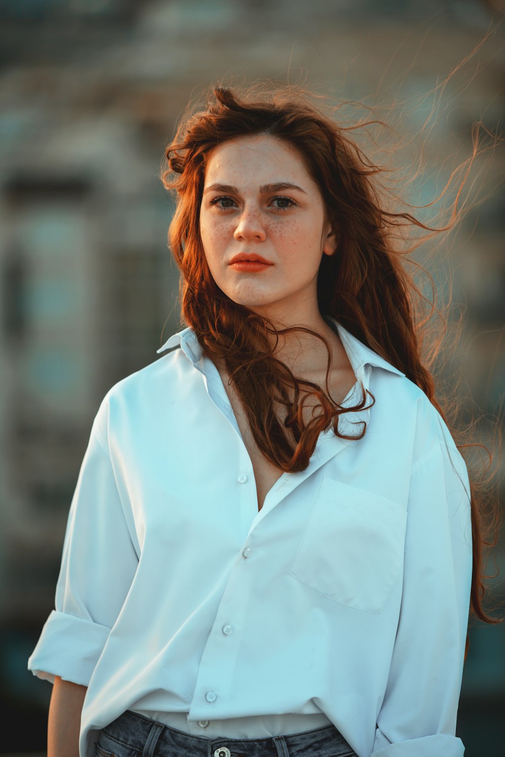 woman in white button-up long-sleeved shirt smiling