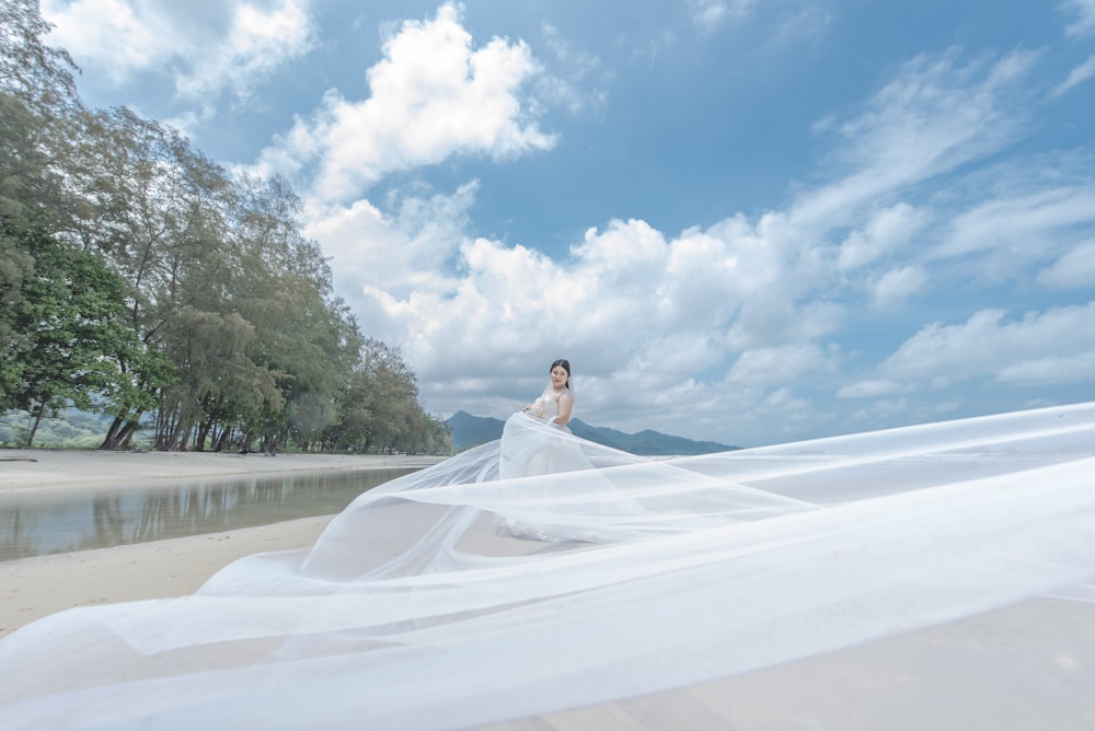 woman in wedding dress under blue sky