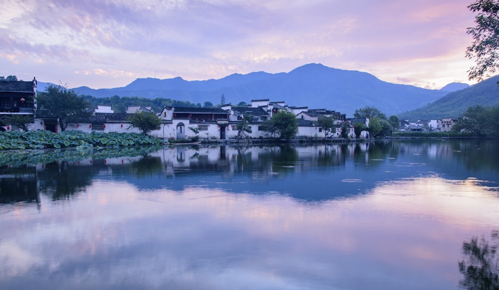 grey cloudy sky over the village and glassy calm river