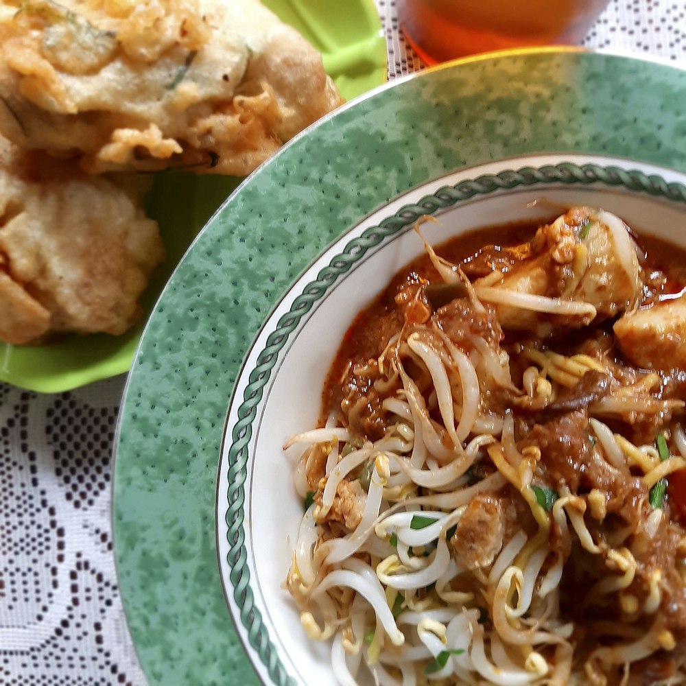 bean sprout stir-fry on white and green plate