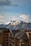 Cozy mountain apartment balcony view with snow-covered peaks in the background.