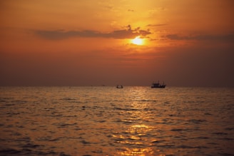 boat sailing in the middle under golden hour
