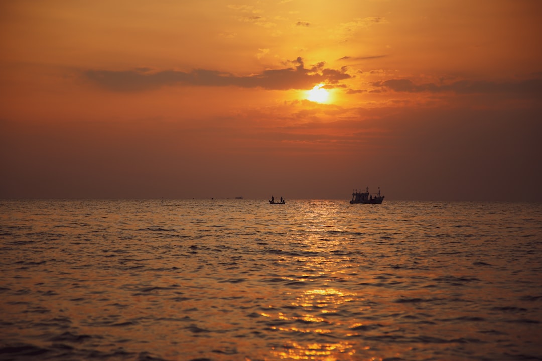 boat sailing in the middle under golden hour