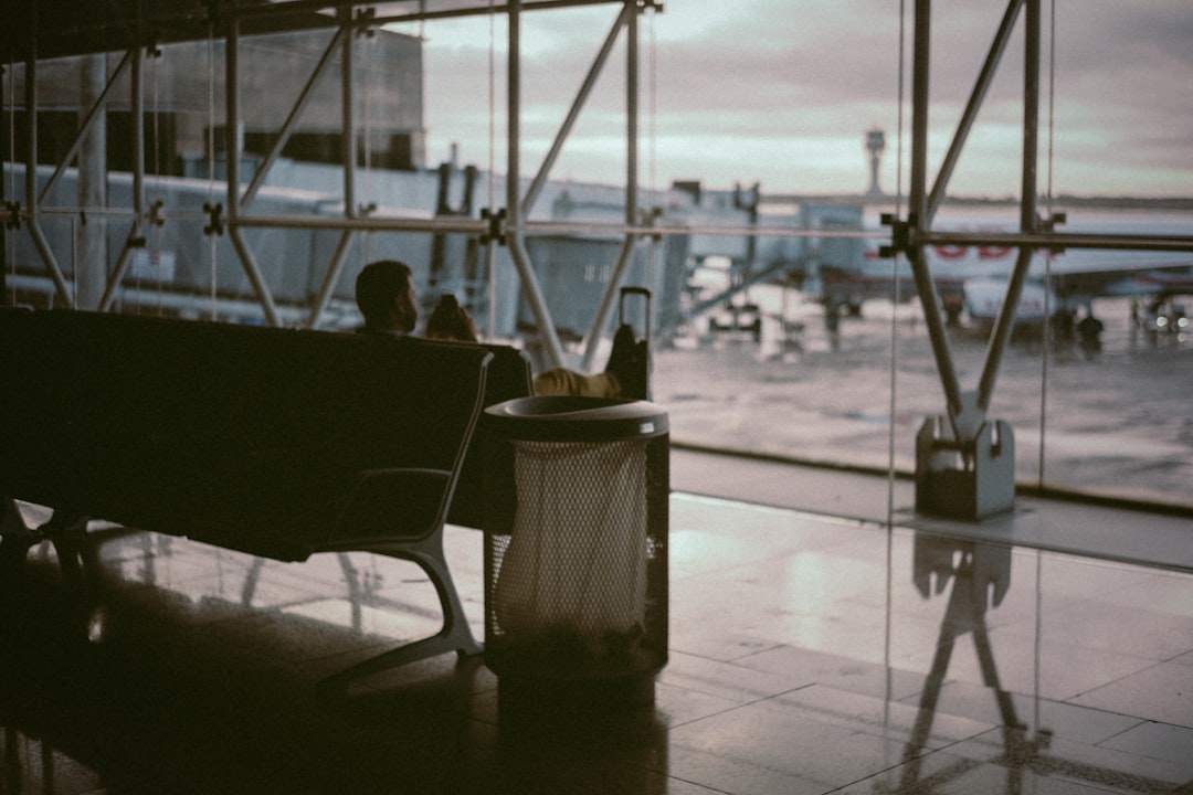 man sitting inside airport's boarding area