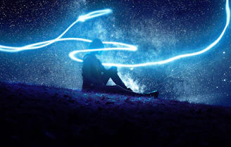 A serene scene showing a person meditating under a starry night sky, surrounded by soft glowing symbols of astrology and healing.