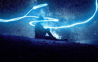 person sitting under blue LED lights