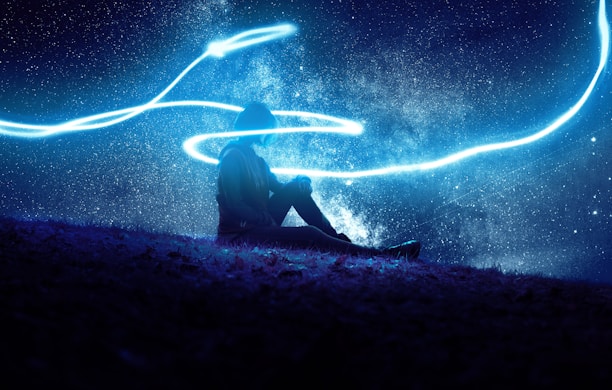 A serene person meditating under a starry night sky with cosmic colors.