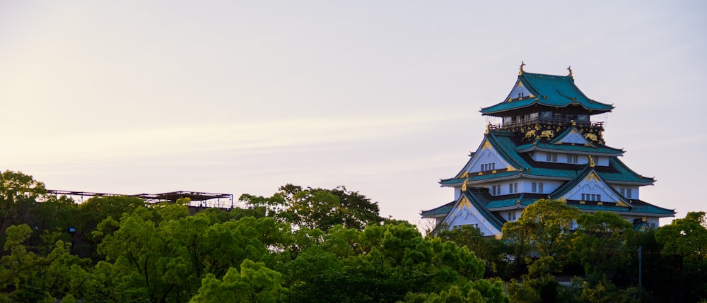 white and gray pagoda temple surrounded by trees during daytime